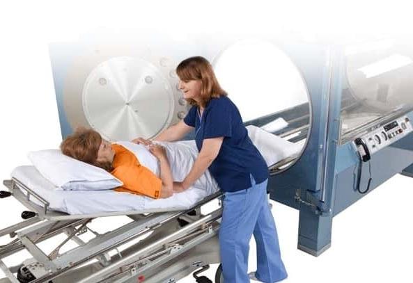 patient and nurse with hyperbaric chamber